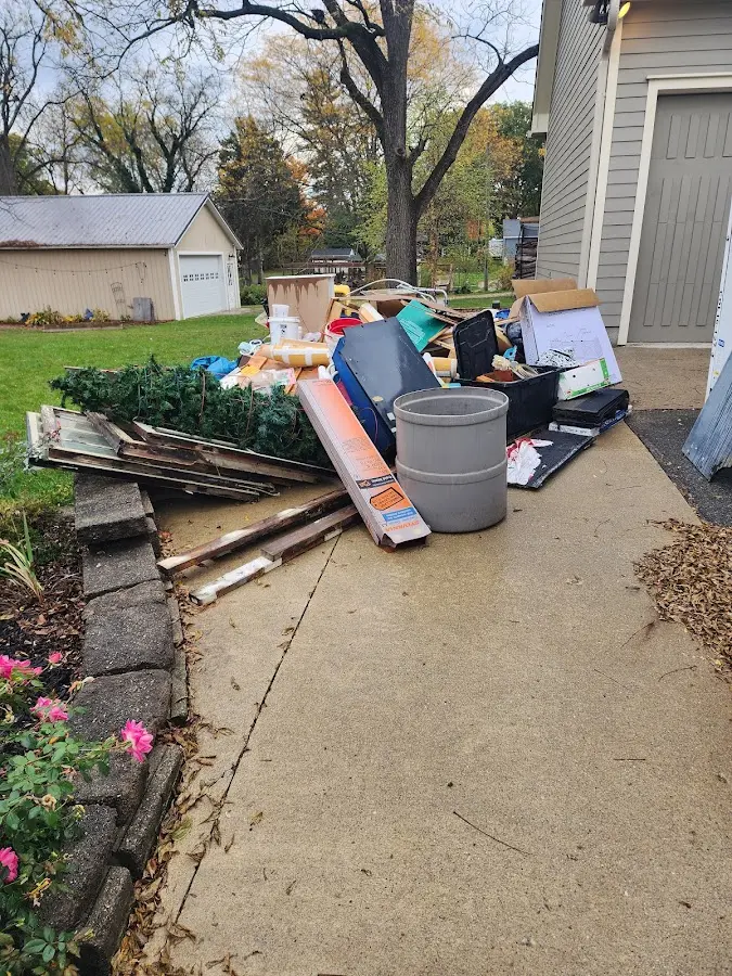 Dumpster being loaded with debris for Roofing Dumpster Rental in Briar Chapel